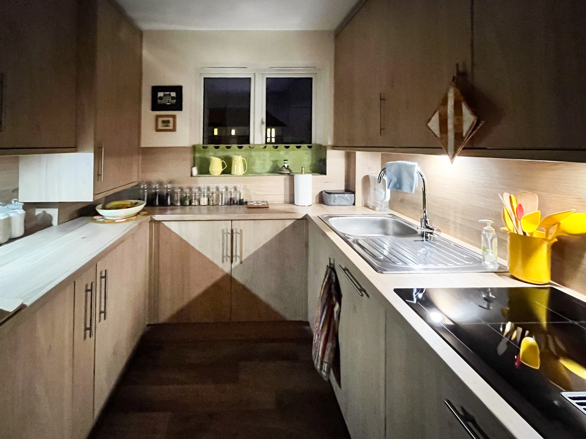 A kitchen with a sink a stove and a window.